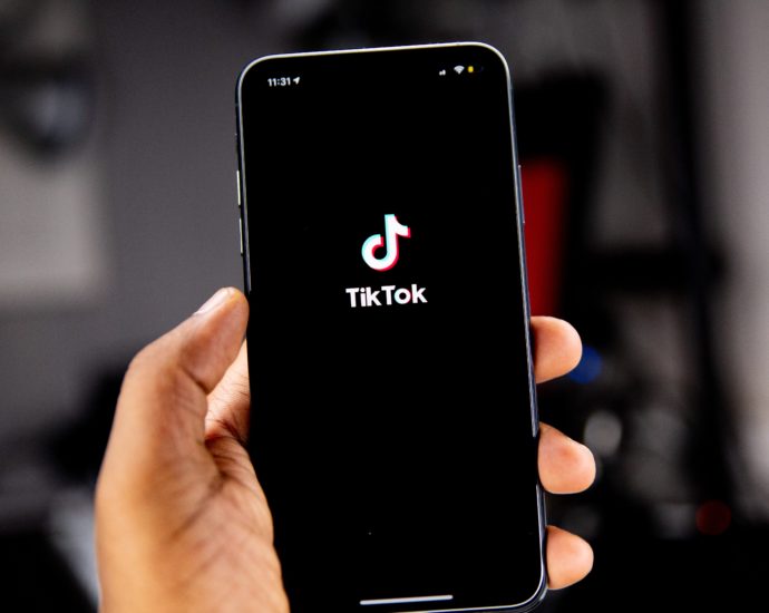 Person holding an Iphone running Tiktok