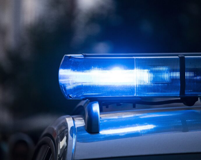 A blue light glowing on top of a police car