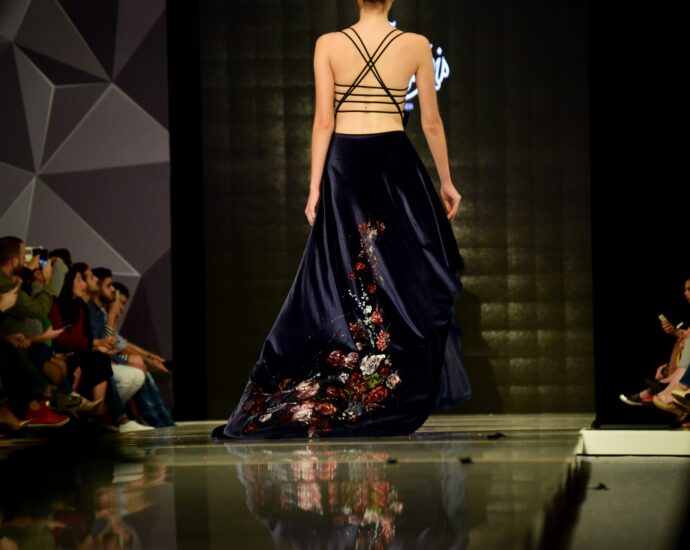Model walking on catwalk in a fashion show.