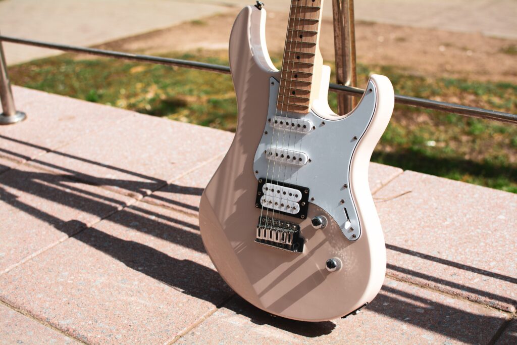 Photo of a pink electric guitar at golden hour