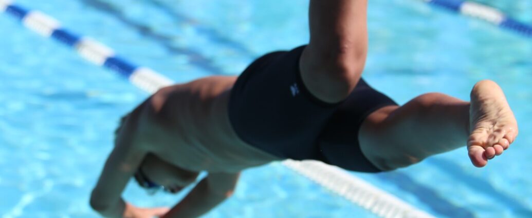 person diving into a swimming pool.