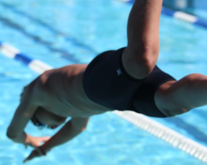 person diving into a swimming pool.
