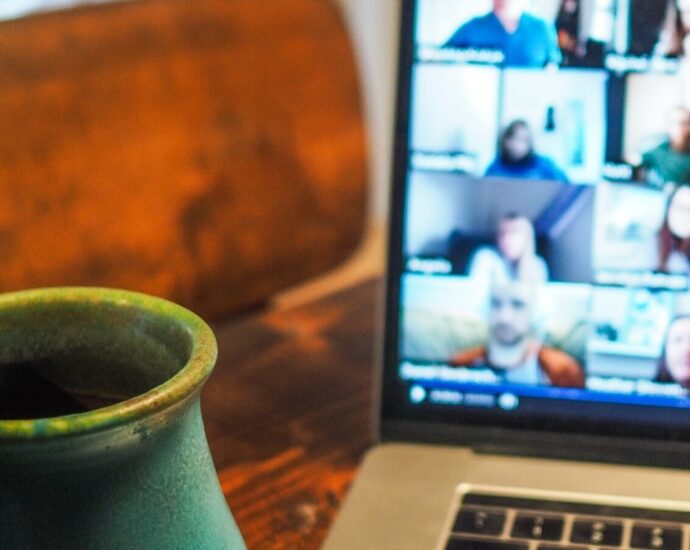 A laptop showing a work call on Zoom.