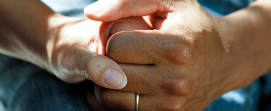 Two hands holding each other