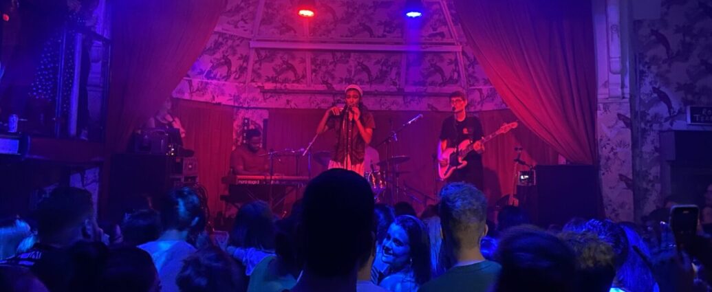 Olivia Dean performing onstage in Manchester