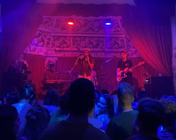 Olivia Dean performing onstage in Manchester
