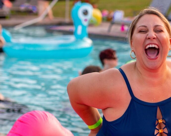 A picture of a smiling woman in a swimming pool