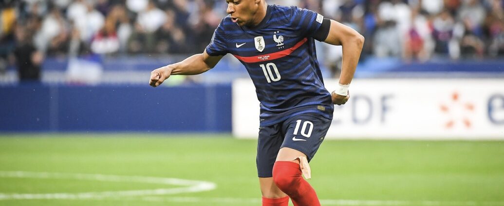 Kylian mbappe kicking a football
