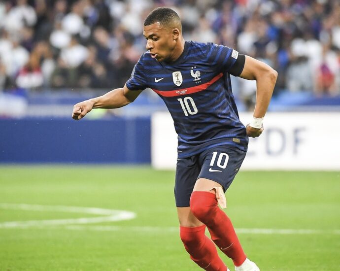 Kylian mbappe kicking a football