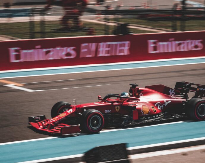 Charles Leclerc's ferrari racing down a straight on a formula one track