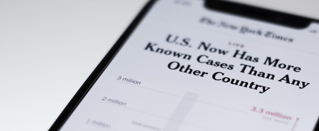 Image shows a phone with a news article shown on-screen [ingore: media and health anxiety]