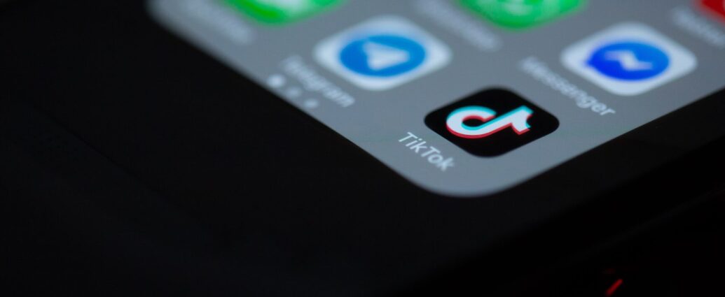 Image displays TikTok app on iPhone home screen.