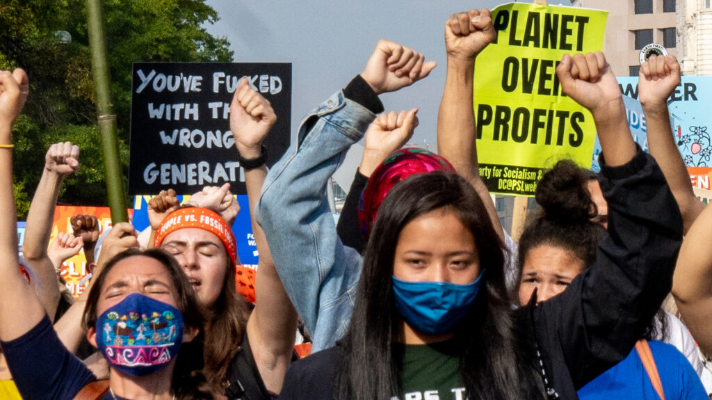 Image of climate protesters on Pennsylvania Avenue. People vs. Fossil Fuels, 10/15/21