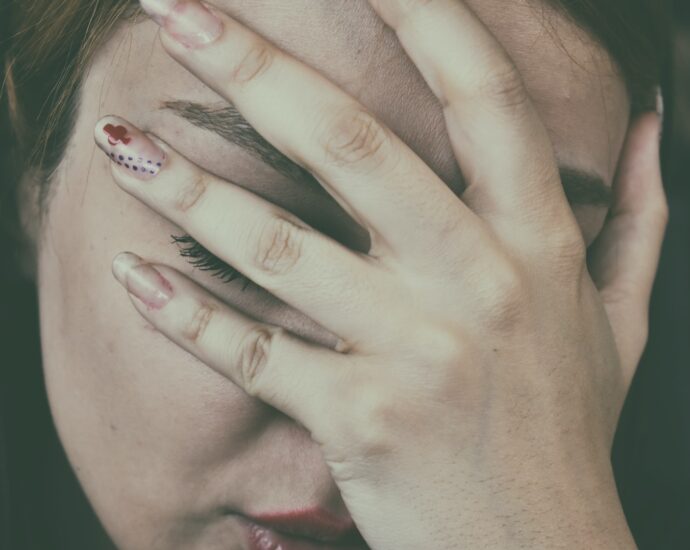 A woman with a migraine clutching her head.