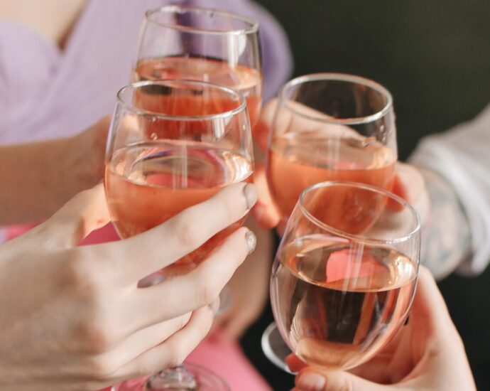 four wine glasses clinking
