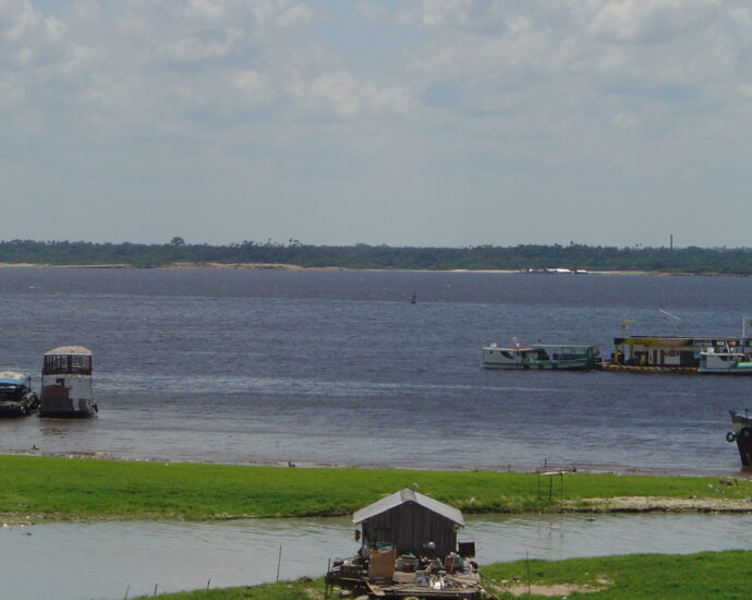 Image shows the Rio Negro from Porto da Manaus Moderna in Brazil.