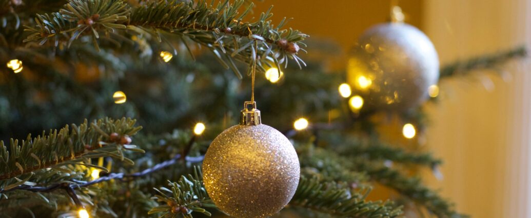 Christmas tree decorated with lights and gold baubles.