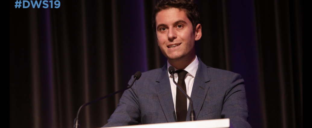Gabriel Attal speaking at a podium