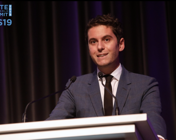 Gabriel Attal speaking at a podium