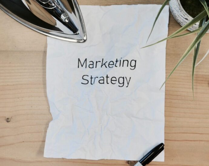 Image shows a piece of paper on a desk with the words 'marketing strategy' printed onto it [FOMO marketing]