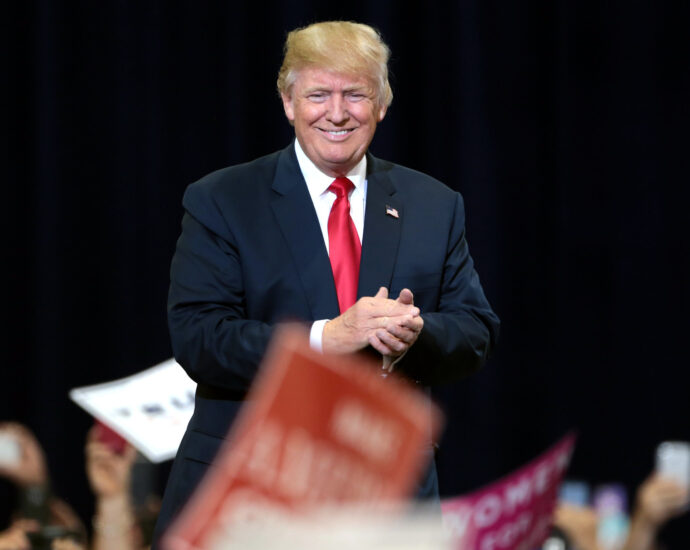 Donald Trump surrounded by Republican supporters.