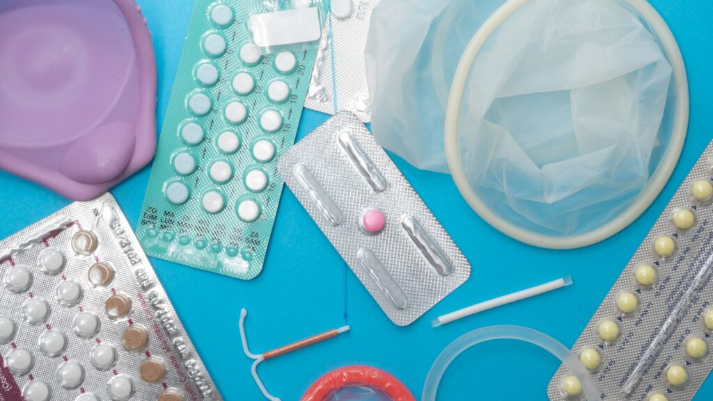 a selection of reproductive health supplies: pills, diaphragm, condoms, vaginal ring, IUD, implant, dmpa, emergency contraception, contraceptive pills