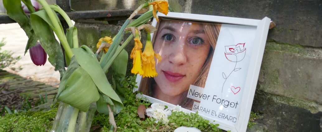 A memorial for Sarah Everard, surrounded by flowers and candles, with an image reading "Never Forget Sarah Everard". [Labour Proposes Mandatory Sexual Violence Training For Police]