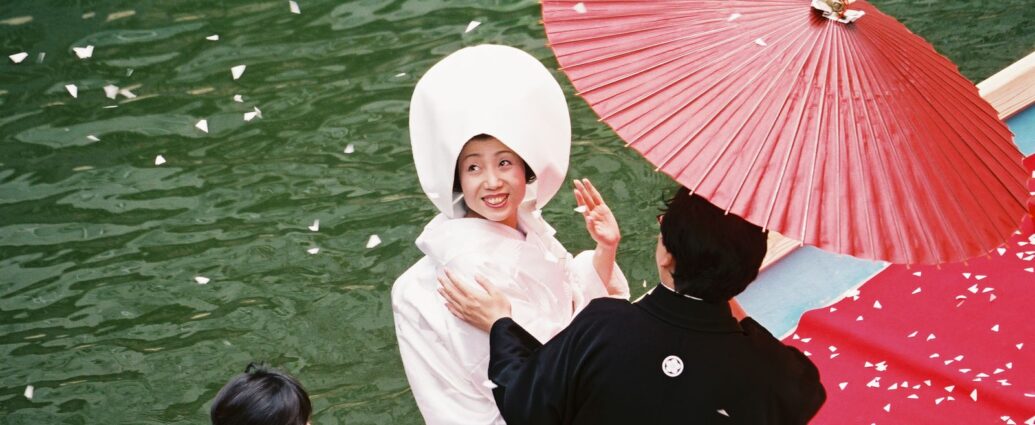 Japanese bride celebrates on a boat on her wedding day. [Japanese law married surnames]