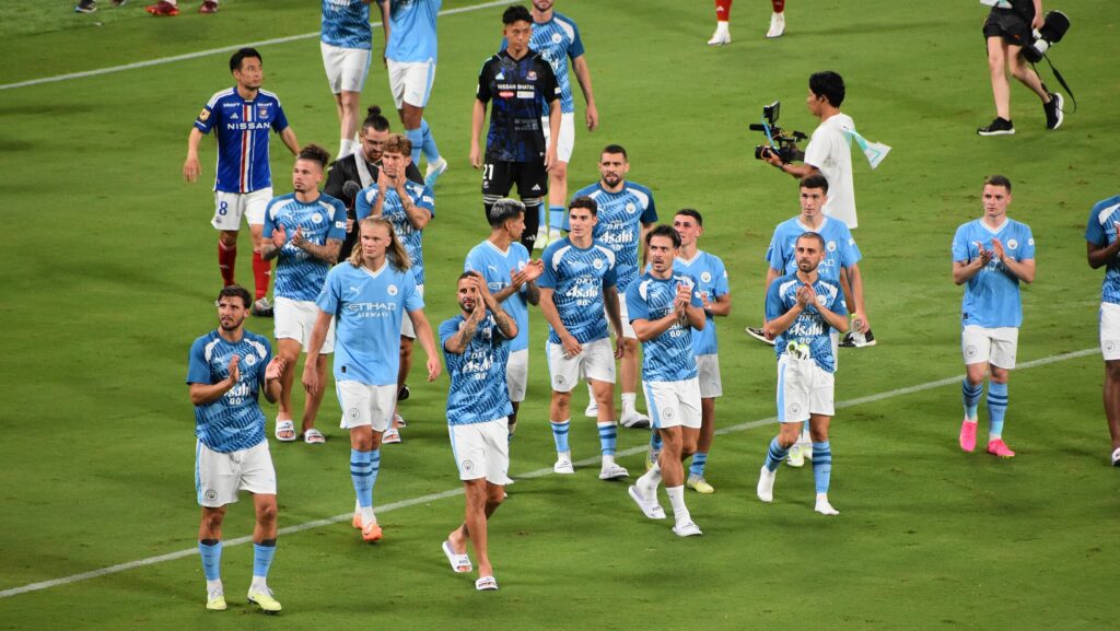 Manchester City walk the pitch at Tokyo National Stadium in 2023.