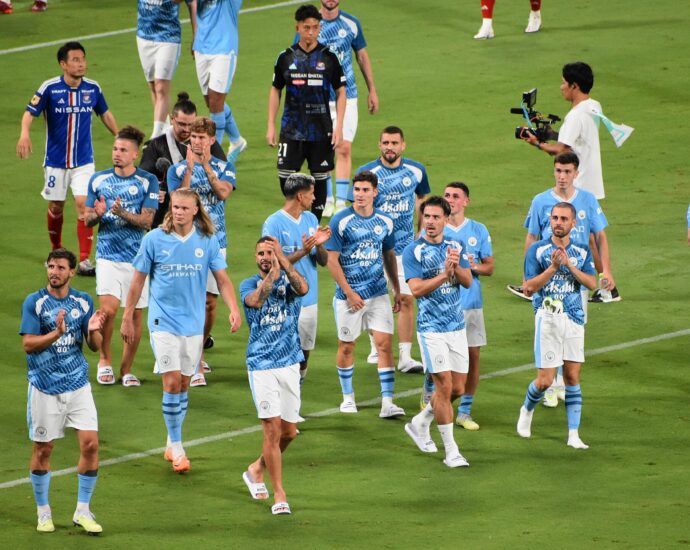 Manchester City walk the pitch at Tokyo National Stadium in 2023.