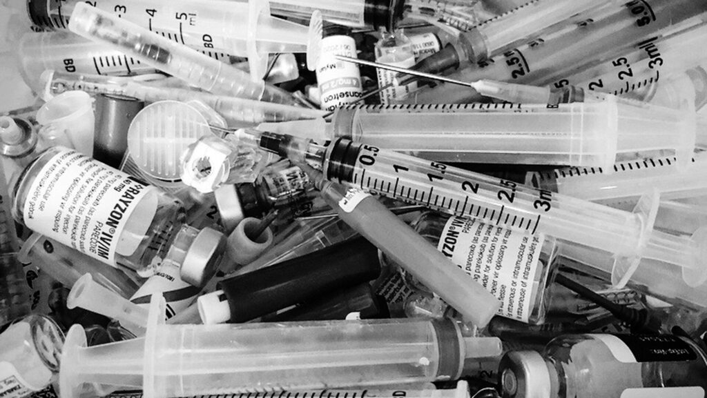 mixture of clear glass and white syringes