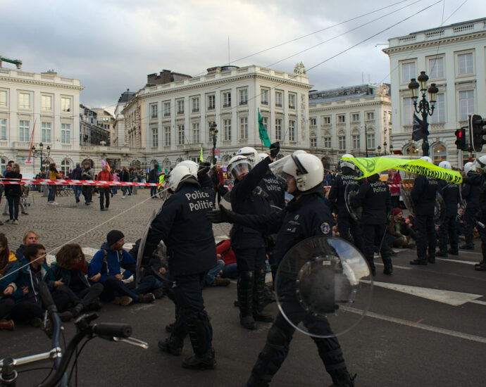 Police approach sitting protestors at an Extinction Rebellion public demonstration, 2019.