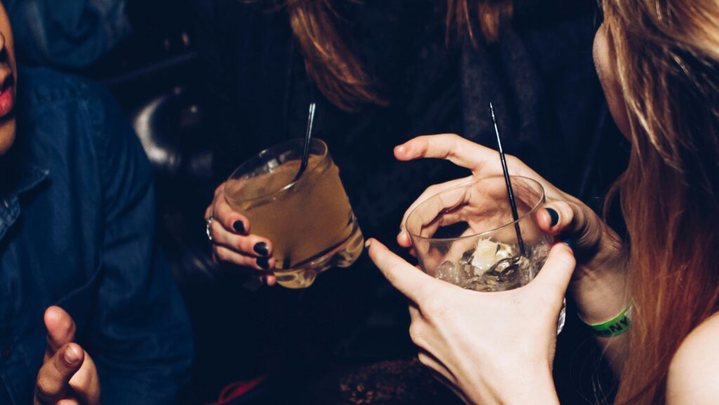 Two women holding drinks