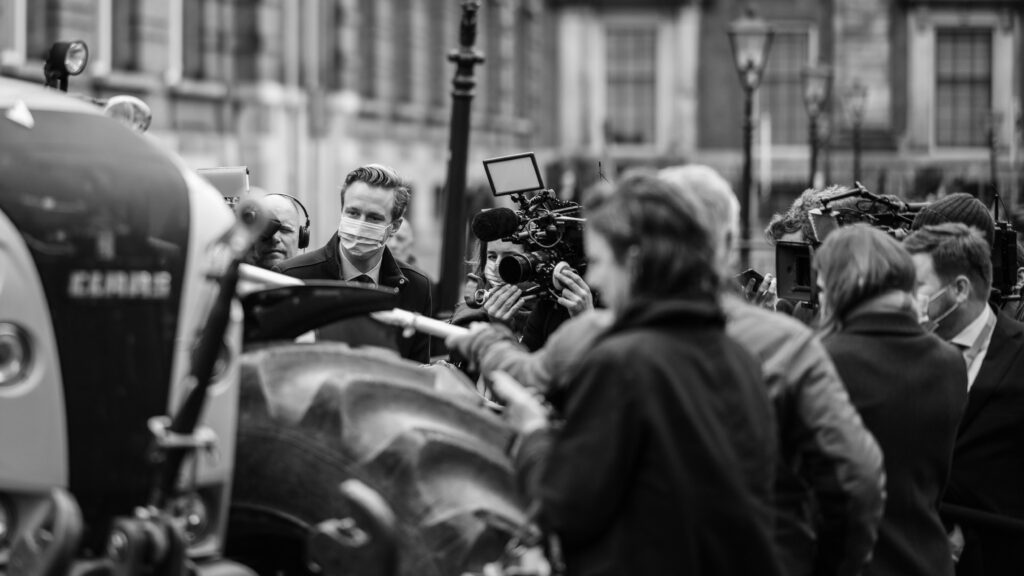 A group of journalists conducting interviews.