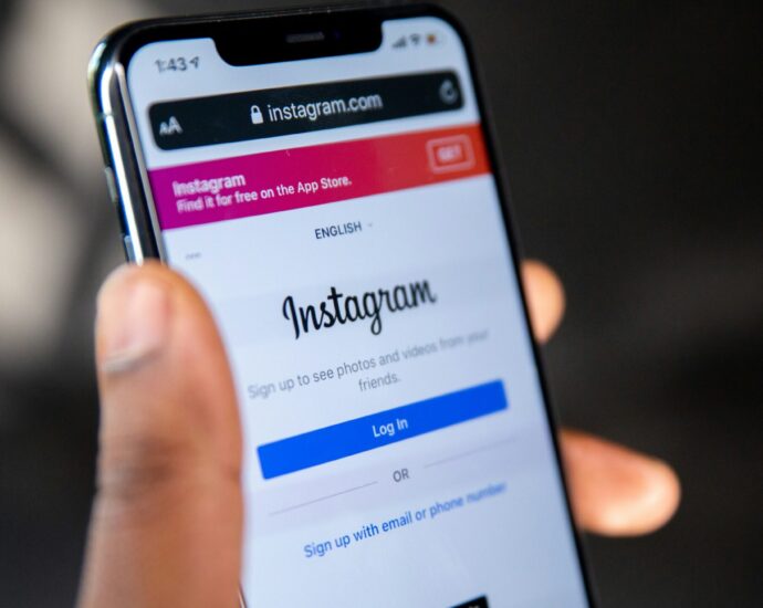 Person holding an iPhone showing Instagram log in page [Instagram political update]