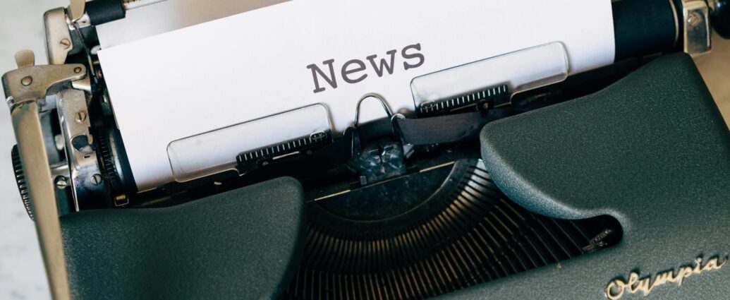 A piece of white paper in a type writer reading the word 'News'. My Journalism Journey