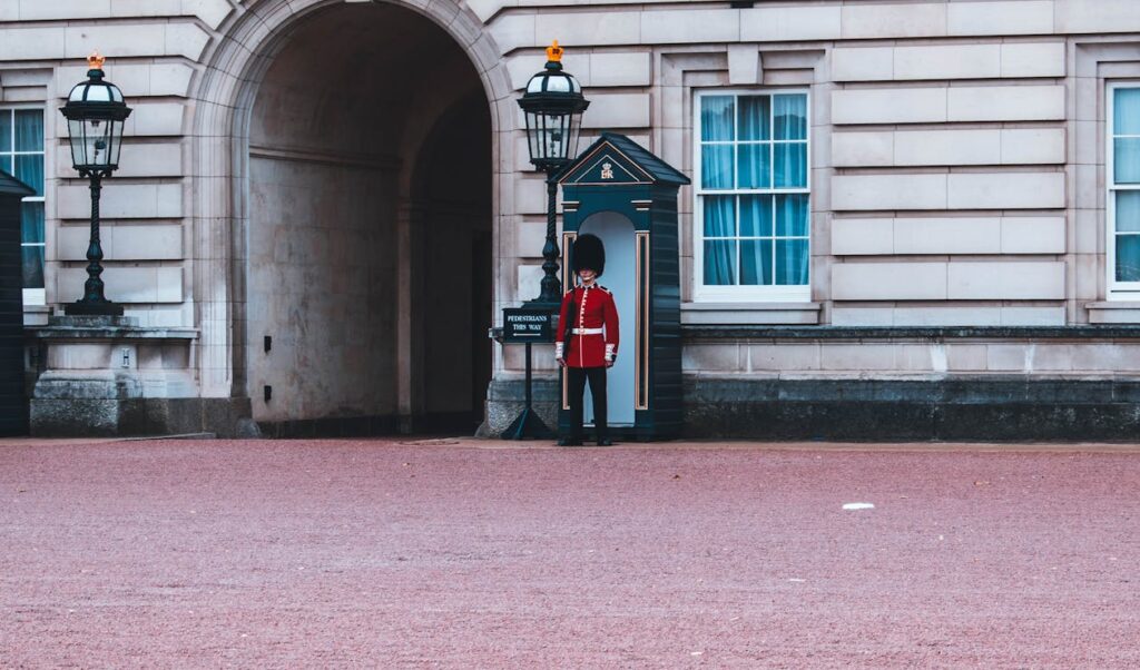 Royals guard standing beside building