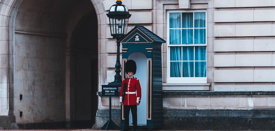 Royals guard standing beside building
