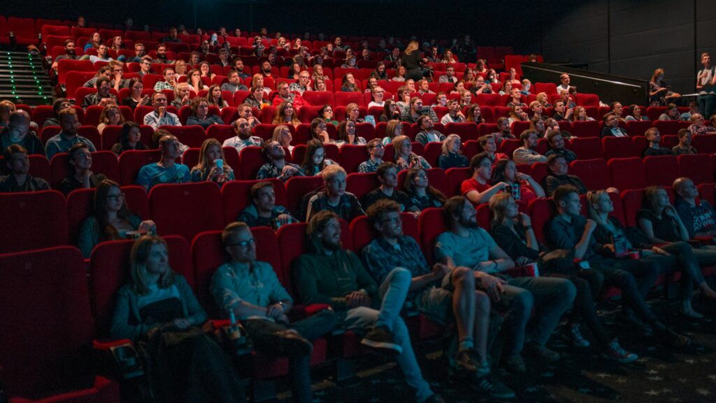 People sitting in a theatre watching a film.