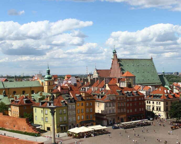An image of Warsaw, where A Real Pain takes place, showing bright buildings and blue skies