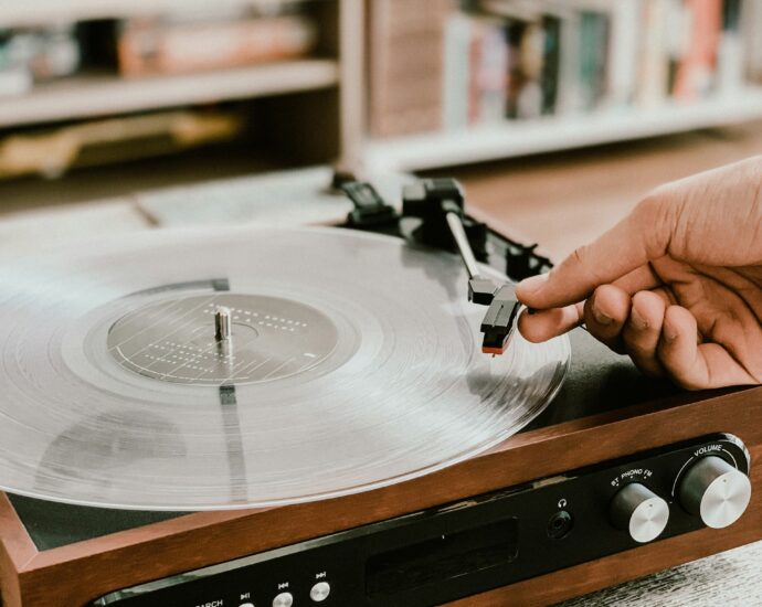 Vinyl record playing on record player in a house.