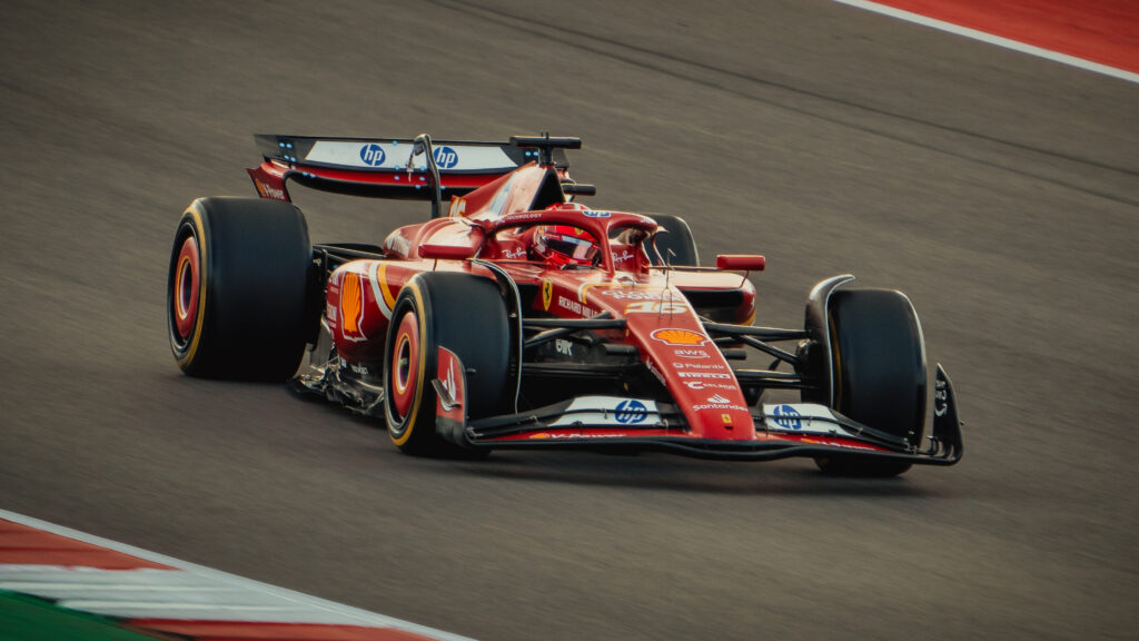 Red Formula 1 car on a track, heading towards the camera