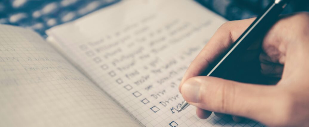A long list of New Year's Resolutions being written in a notebook