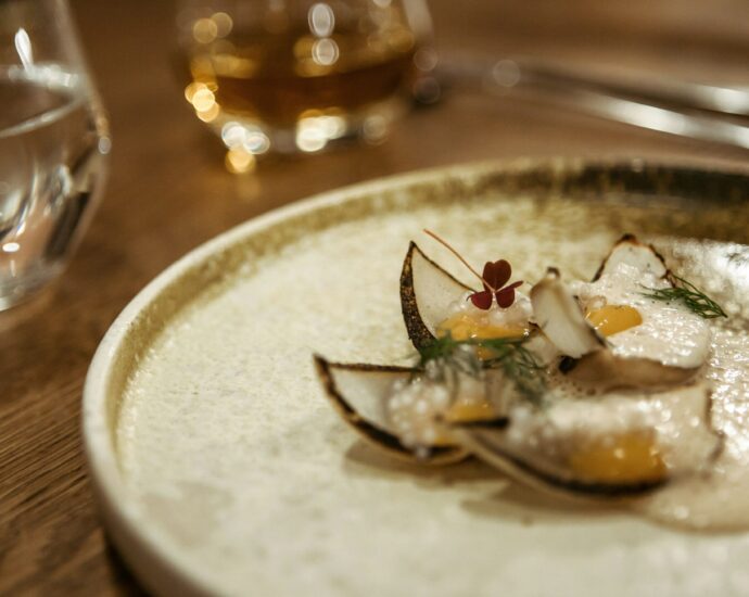 A small plate with a tiny portion of food on it.
