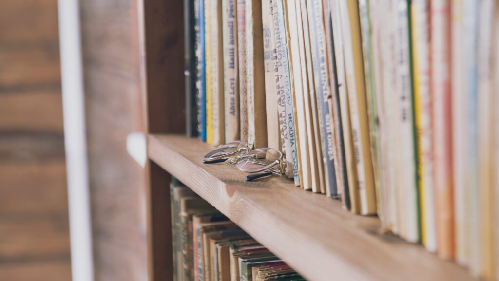 A pair of glasses on a bookshelf