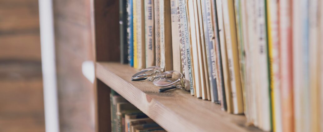 A pair of glasses on a bookshelf