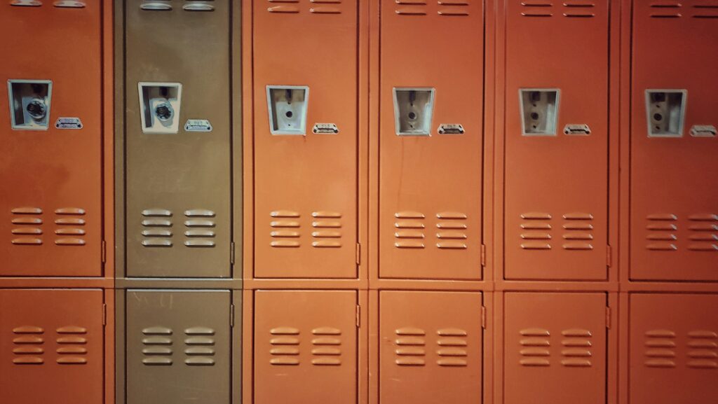Orange lockers in school hallway representing Adolescence