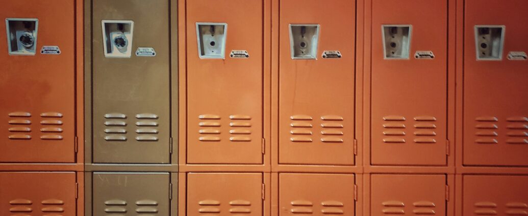 Orange lockers in school hallway representing Adolescence