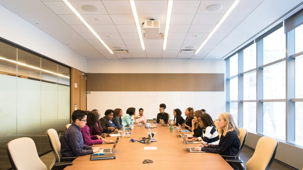 Women sitting around a large table in a business meeting in an office