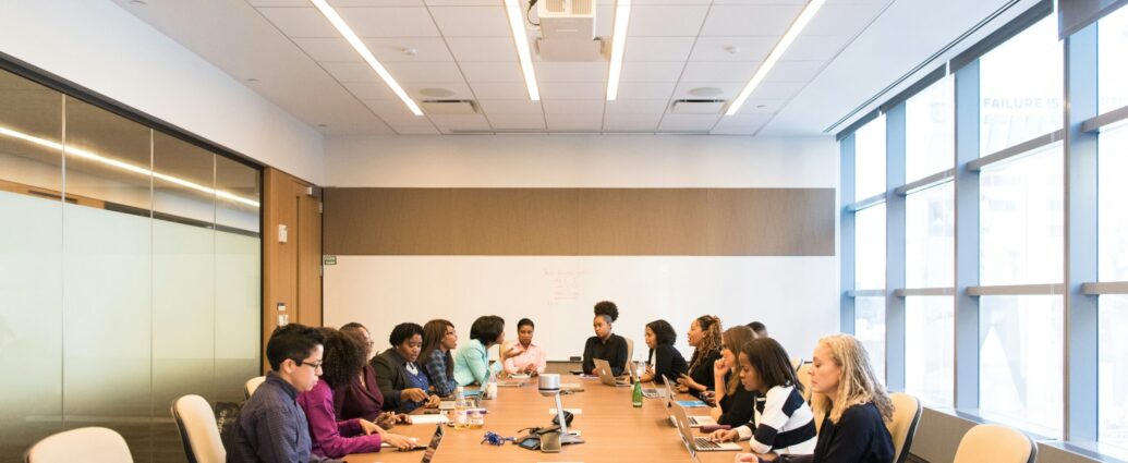 Women sitting around a large table in a business meeting in an office